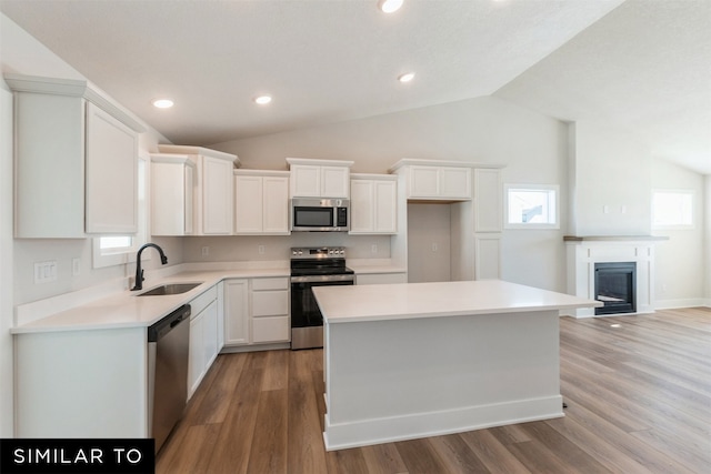 kitchen with stainless steel appliances, white cabinets, and a sink