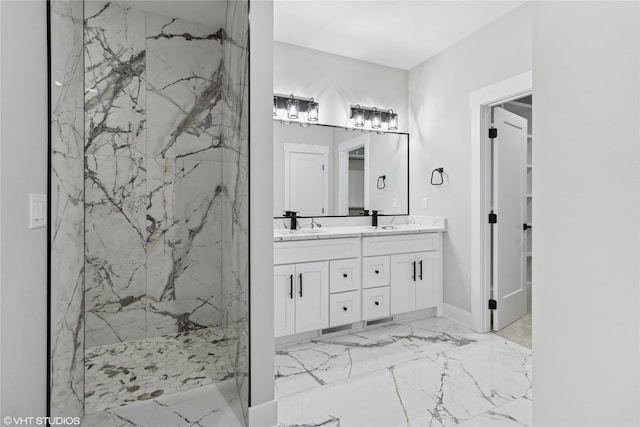 full bathroom with a marble finish shower, double vanity, marble finish floor, and a sink