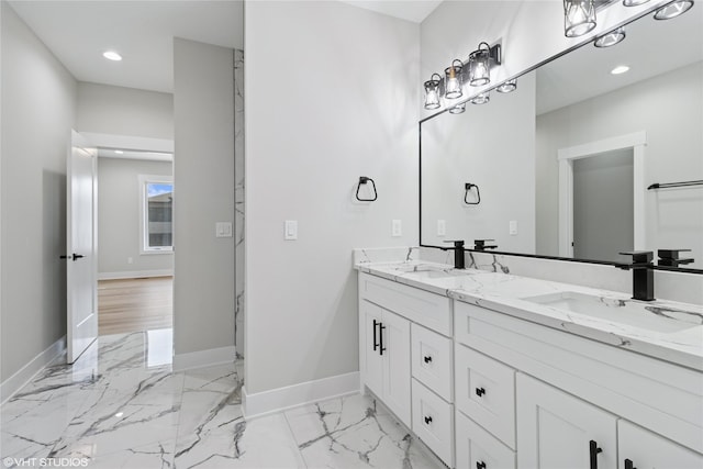 full bath with a sink, baseboards, recessed lighting, and marble finish floor