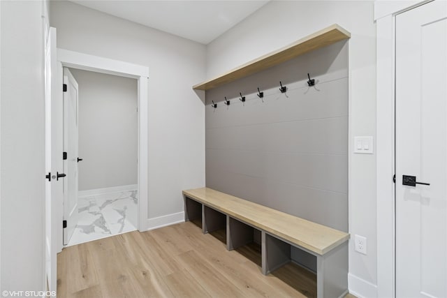 mudroom with baseboards and wood finished floors