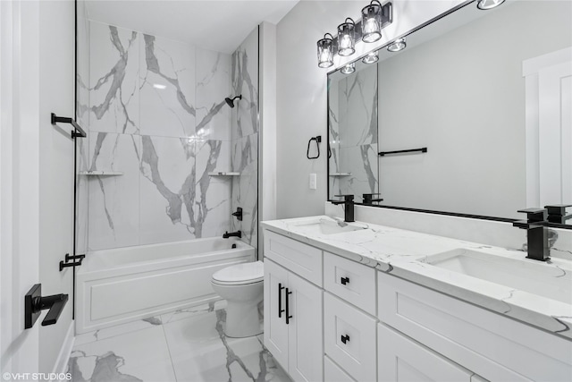 bathroom with double vanity, marble finish floor, a sink, and toilet
