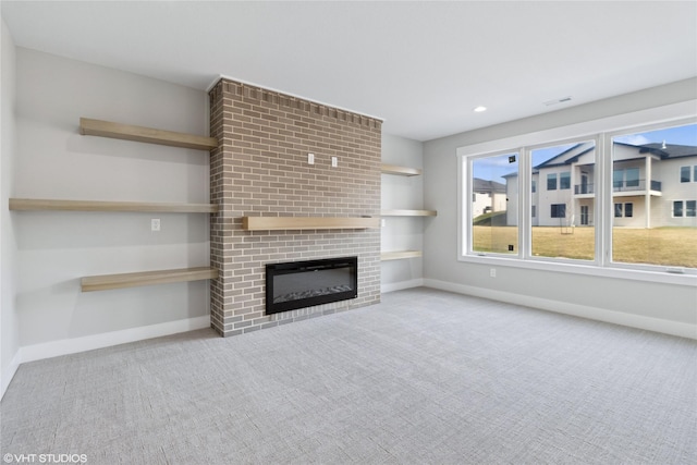 unfurnished living room with a fireplace, visible vents, recessed lighting, carpet flooring, and baseboards