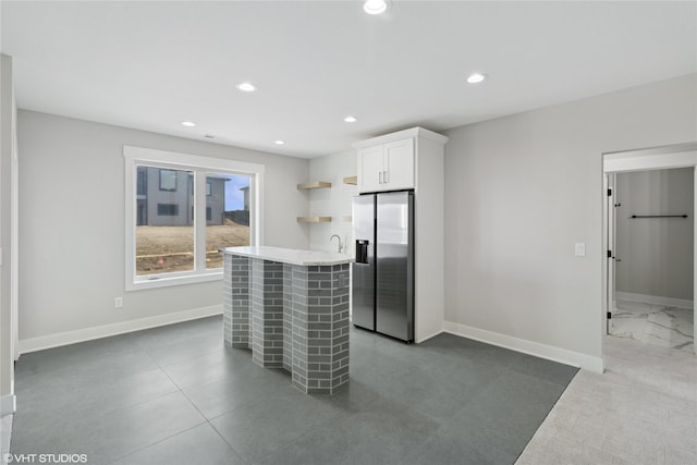 kitchen featuring stainless steel fridge with ice dispenser, white cabinetry, open shelves, recessed lighting, and baseboards