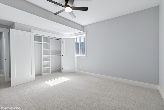 unfurnished bedroom featuring ceiling fan, a closet, carpet flooring, and baseboards