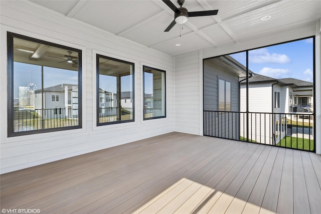 exterior space with beamed ceiling, coffered ceiling, and ceiling fan
