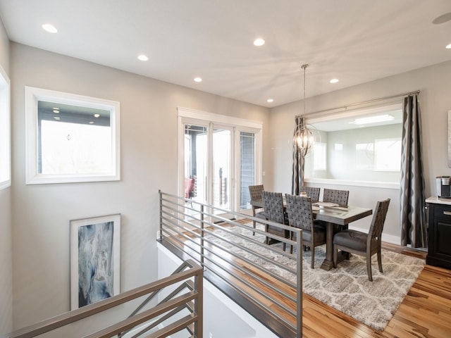 dining area with wood finished floors, a notable chandelier, and recessed lighting