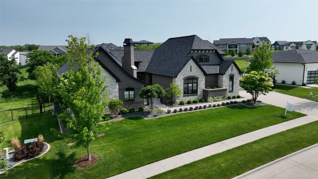 740 Century Cir, Waukee, IA 50263 - french country home with stone siding, a residential view, stucco siding, and a chimney