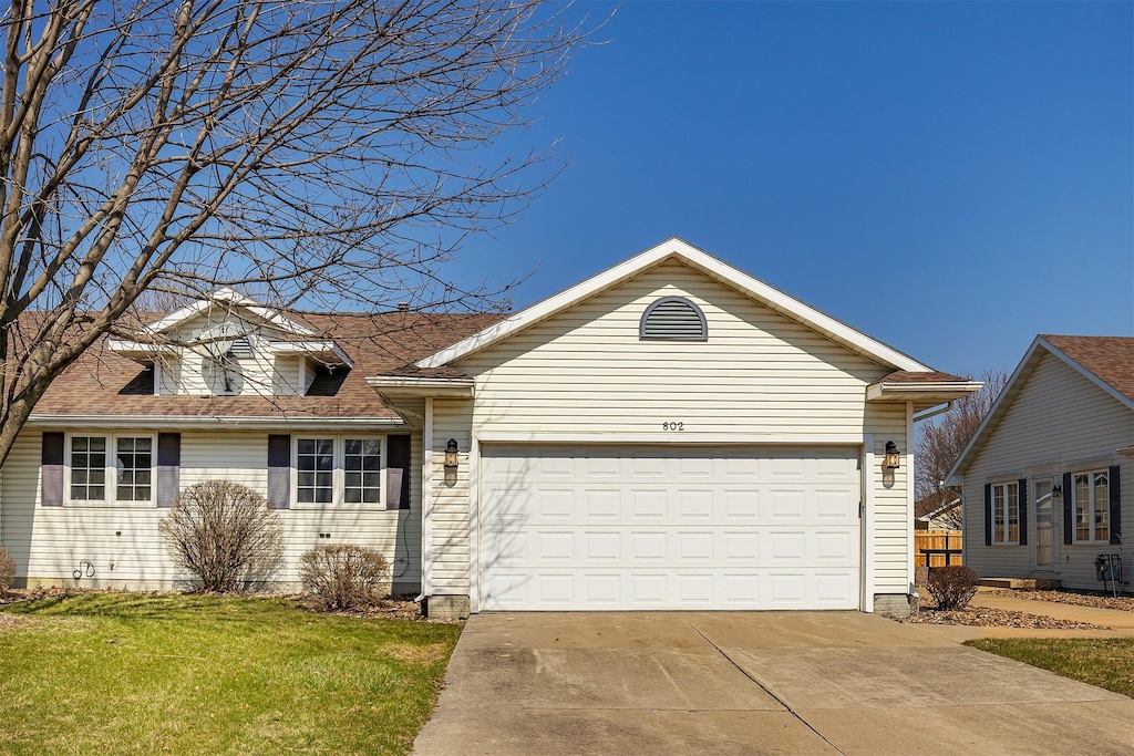 802 NE 5th St, Ankeny, IA 50021 - view of front of house with a front yard, an attached garage, and concrete driveway