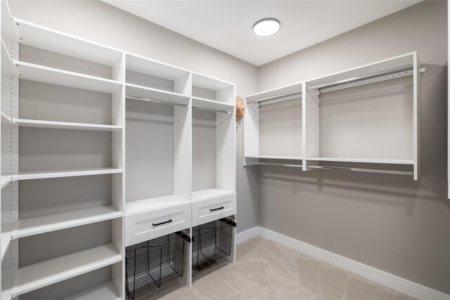 5009 148th Cir, Urbandale, IA 50323 - walk in closet featuring light carpet