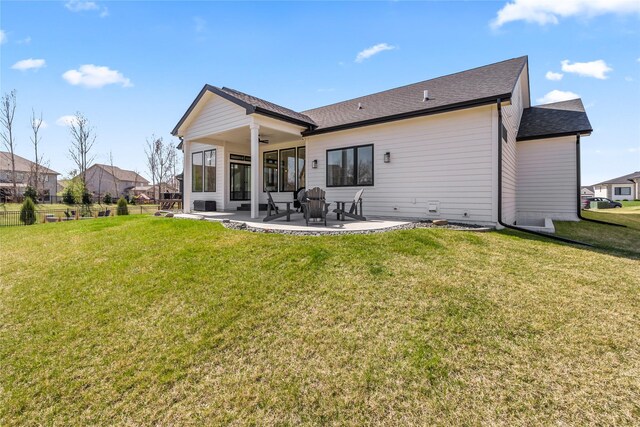 5009 148th Cir, Urbandale, IA 50323 - back of house with a ceiling fan, a patio area, and a shingled roof