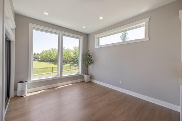 5009 148th Cir, Urbandale, IA 50323 - spare room with light wood-style flooring, baseboards, and recessed lighting
