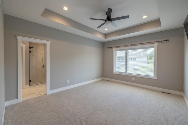 5009 148th Cir, Urbandale, IA 50323 - empty room featuring a tray ceiling, light carpet, baseboards, recessed lighting, and a ceiling fan