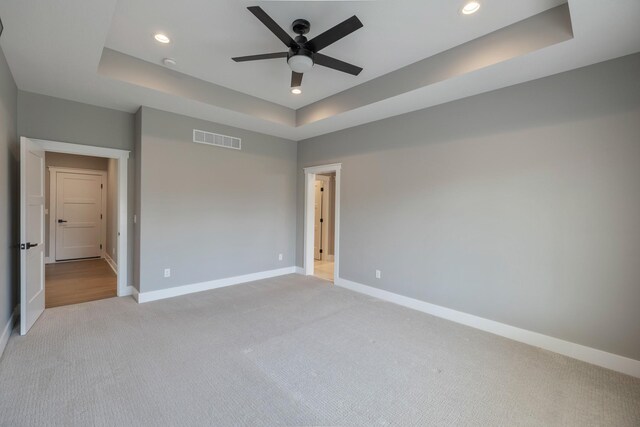 5009 148th Cir, Urbandale, IA 50323 - unfurnished room featuring a tray ceiling, light colored carpet, baseboards, ceiling fan, and recessed lighting