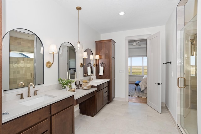 5027 NE Seneca Dr, Ankeny, IA 50021 - full bathroom featuring ensuite bathroom, two vanities, a stall shower, a ceiling fan, and tile patterned floors