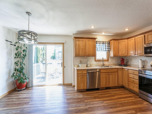 2917 SW Coves Dr, Ankeny, IA 50023 - kitchen featuring a sink, light countertops, dark wood-type flooring, and stainless steel appliances