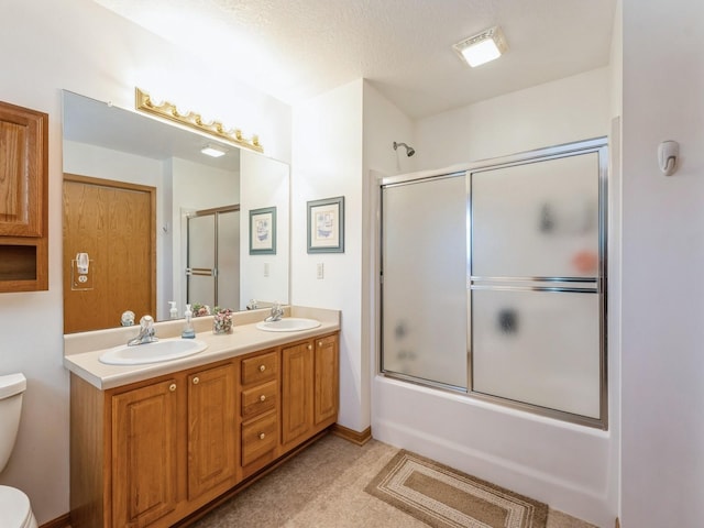 2917 SW Coves Dr, Ankeny, IA 50023 - full bath featuring toilet, double vanity, a sink, and combined bath / shower with glass door