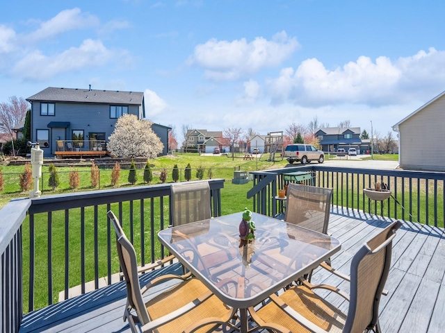 2917 SW Coves Dr, Ankeny, IA 50023 - wooden deck with outdoor dining area, fence, a residential view, and a lawn