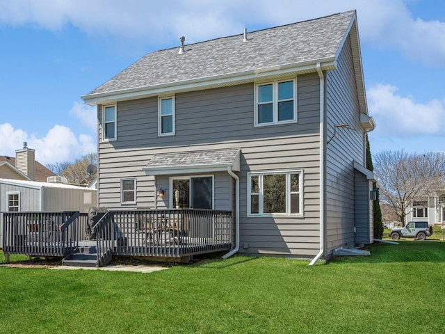 2917 SW Coves Dr, Ankeny, IA 50023 - back of house featuring a shingled roof, a deck, and a lawn