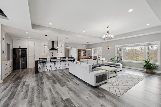 875 Roman Rd, Waukee, IA 50263 - living room featuring recessed lighting, wood finished floors, a chandelier, and baseboards