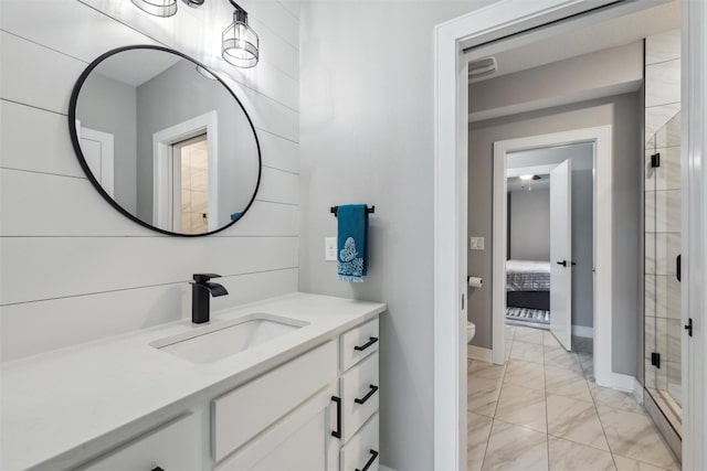 875 Roman Rd, Waukee, IA 50263 - full bathroom featuring marble finish floors, vanity, a stall shower, toilet, and baseboards