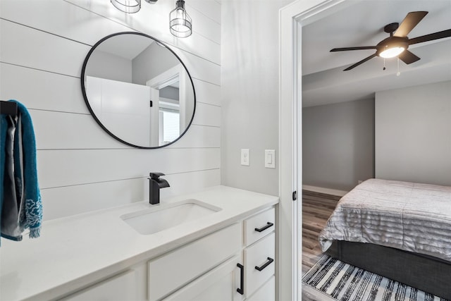 875 Roman Rd, Waukee, IA 50263 - bathroom featuring vanity, wood finished floors, and a ceiling fan