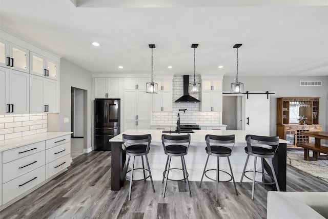 875 Roman Rd, Waukee, IA 50263 - kitchen featuring smart refrigerator, wall chimney exhaust hood, a large island, tasteful backsplash, and recessed lighting