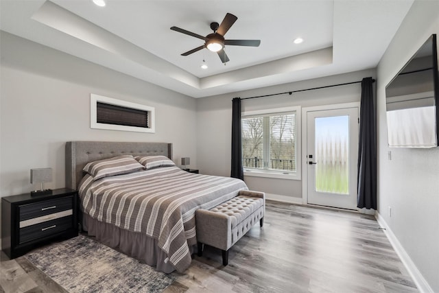 875 Roman Rd, Waukee, IA 50263 - bedroom with a tray ceiling, access to exterior, wood finished floors, baseboards, and recessed lighting