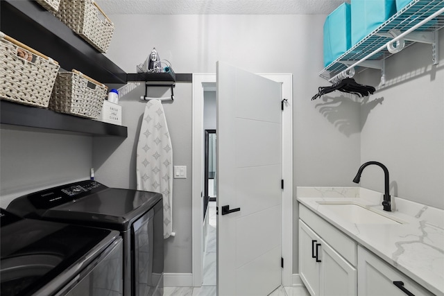 875 Roman Rd, Waukee, IA 50263 - laundry room with washing machine and dryer, cabinet space, a textured ceiling, and baseboards