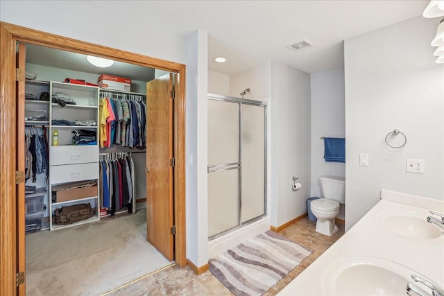 5417 NW 92nd St, Johnston, IA 50131 - bathroom with a shower stall, a walk in closet, and double vanity