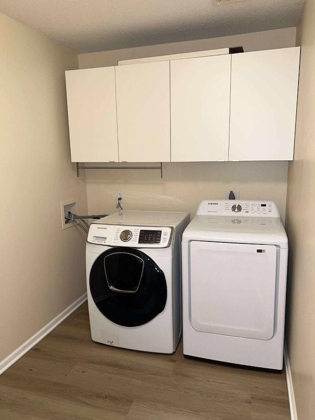 5417 NW 92nd St, Johnston, IA 50131 - washroom with cabinet space, independent washer and dryer, and light wood-style floors