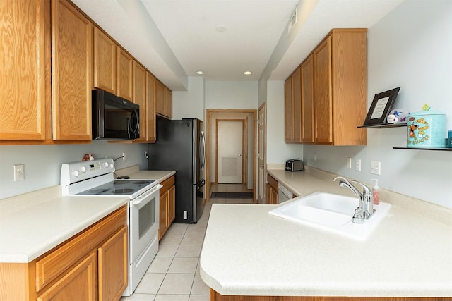 921 10th St SE, Altoona, IA 50009 - kitchen with black microwave, white electric range oven, light tile patterned flooring, recessed lighting, and light countertops