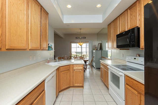 921 10th St SE, Altoona, IA 50009 - kitchen with white appliances, a peninsula, light tile patterned flooring, a tray ceiling, and a sink