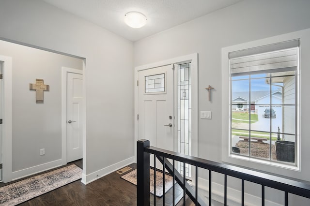8704 Highland Oaks Dr, Johnston, IA 50131 - foyer featuring dark wood-style flooring and baseboards