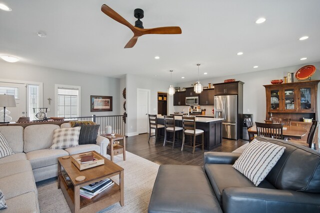 8704 Highland Oaks Dr, Johnston, IA 50131 - living room featuring a ceiling fan, dark wood-style floors, and recessed lighting