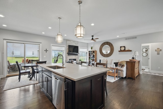 8704 Highland Oaks Dr, Johnston, IA 50131 - kitchen with a sink, stainless steel dishwasher, a fireplace, a ceiling fan, and recessed lighting
