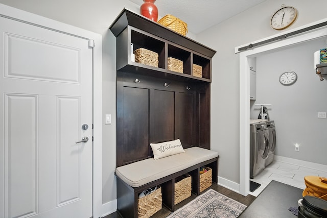 8704 Highland Oaks Dr, Johnston, IA 50131 - mudroom featuring independent washer and dryer, baseboards, and a barn door