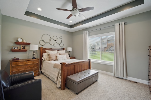 8704 Highland Oaks Dr, Johnston, IA 50131 - bedroom with a raised ceiling, recessed lighting, light carpet, baseboards, and a ceiling fan