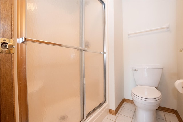 5925 Ep True Pkwy Unit 22, West Des Moines, IA 50266 - bathroom featuring baseboards, a stall shower, tile patterned floors, and toilet