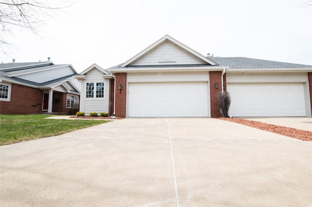 5925 Ep True Pkwy Unit 22, West Des Moines, IA 50266 - view of front of property featuring driveway, a garage, brick siding, a front lawn, and a shingled roof