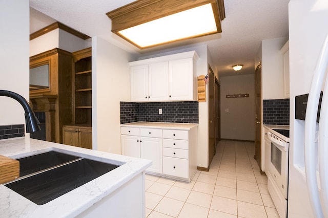 5925 Ep True Pkwy Unit 22, West Des Moines, IA 50266 - kitchen featuring white appliances, a sink, decorative backsplash, white cabinets, and light stone counters