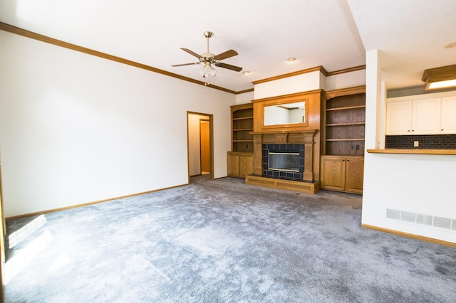 5925 Ep True Pkwy Unit 22, West Des Moines, IA 50266 - unfurnished living room featuring carpet floors, ornamental molding, a ceiling fan, a tiled fireplace, and baseboards
