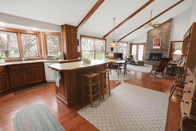 1113 Bruce Ln, Pella, IA 50219 - kitchen with high vaulted ceiling, ceiling fan, a sink, white dishwasher, and beam ceiling