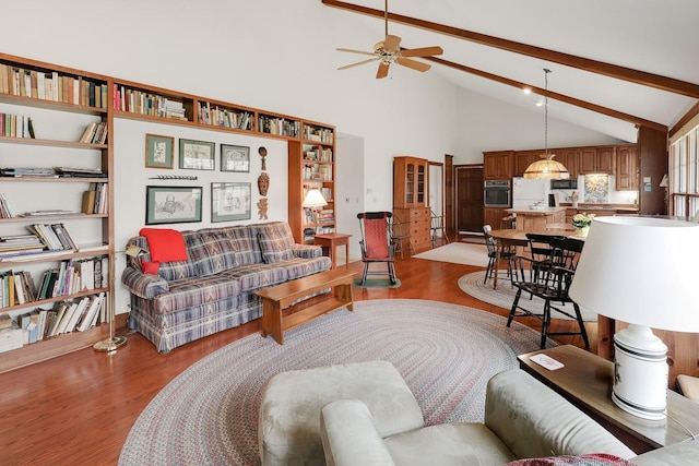 1113 Bruce Ln, Pella, IA 50219 - living room featuring high vaulted ceiling, ceiling fan, beam ceiling, and wood finished floors