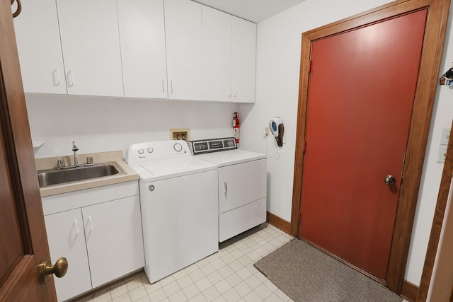 1113 Bruce Ln, Pella, IA 50219 - laundry area with separate washer and dryer, baseboards, light tile patterned floors, cabinet space, and a sink