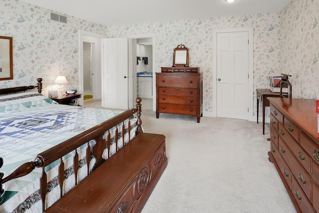 1113 Bruce Ln, Pella, IA 50219 - bedroom featuring visible vents, ensuite bath, light carpet, and wallpapered walls