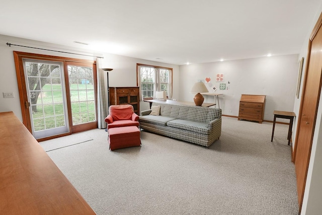1113 Bruce Ln, Pella, IA 50219 - living area with visible vents, recessed lighting, and light carpet