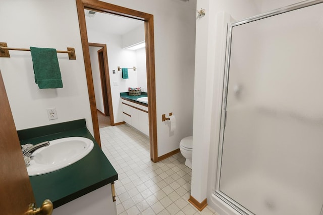 1113 Bruce Ln, Pella, IA 50219 - bathroom featuring tile patterned floors, toilet, vanity, and a stall shower