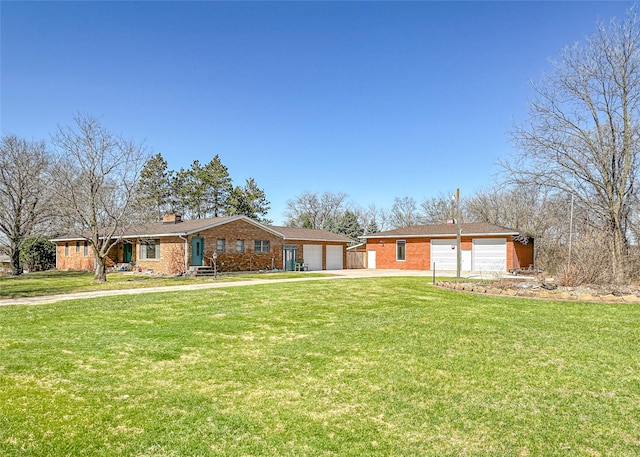 1009 198th Pl, Pella, IA 50219 - ranch-style home with brick siding, a front lawn, concrete driveway, and a chimney