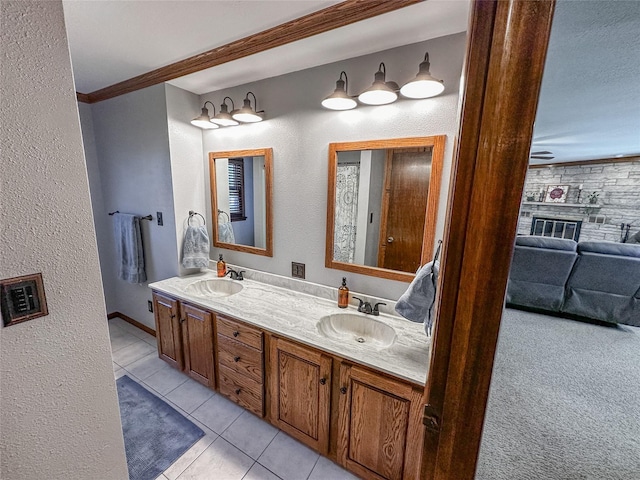 1009 198th Pl, Pella, IA 50219 - full bath featuring tile patterned floors, double vanity, crown molding, a textured wall, and a ceiling fan