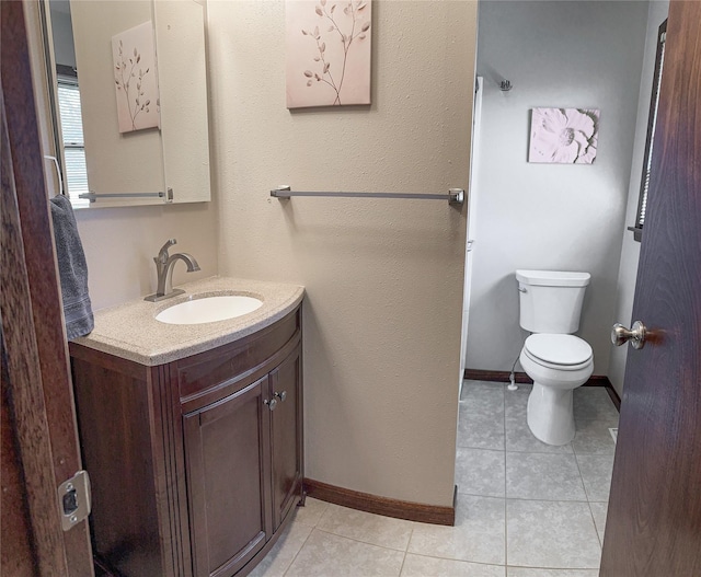 1009 198th Pl, Pella, IA 50219 - bathroom with toilet, vanity, tile patterned floors, and baseboards
